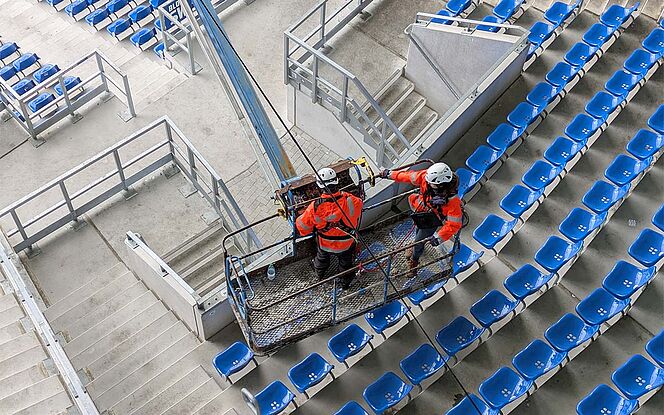 KSC Stadion Karlsruhe »BBBank Wildpark« Kollegen auf der Arbeitsbühne über den Stadionplätzen